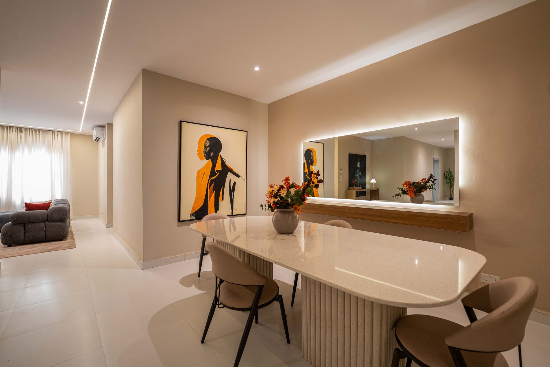 Dining space at The Metropolis Lekki with backlit mirror and contemporary art