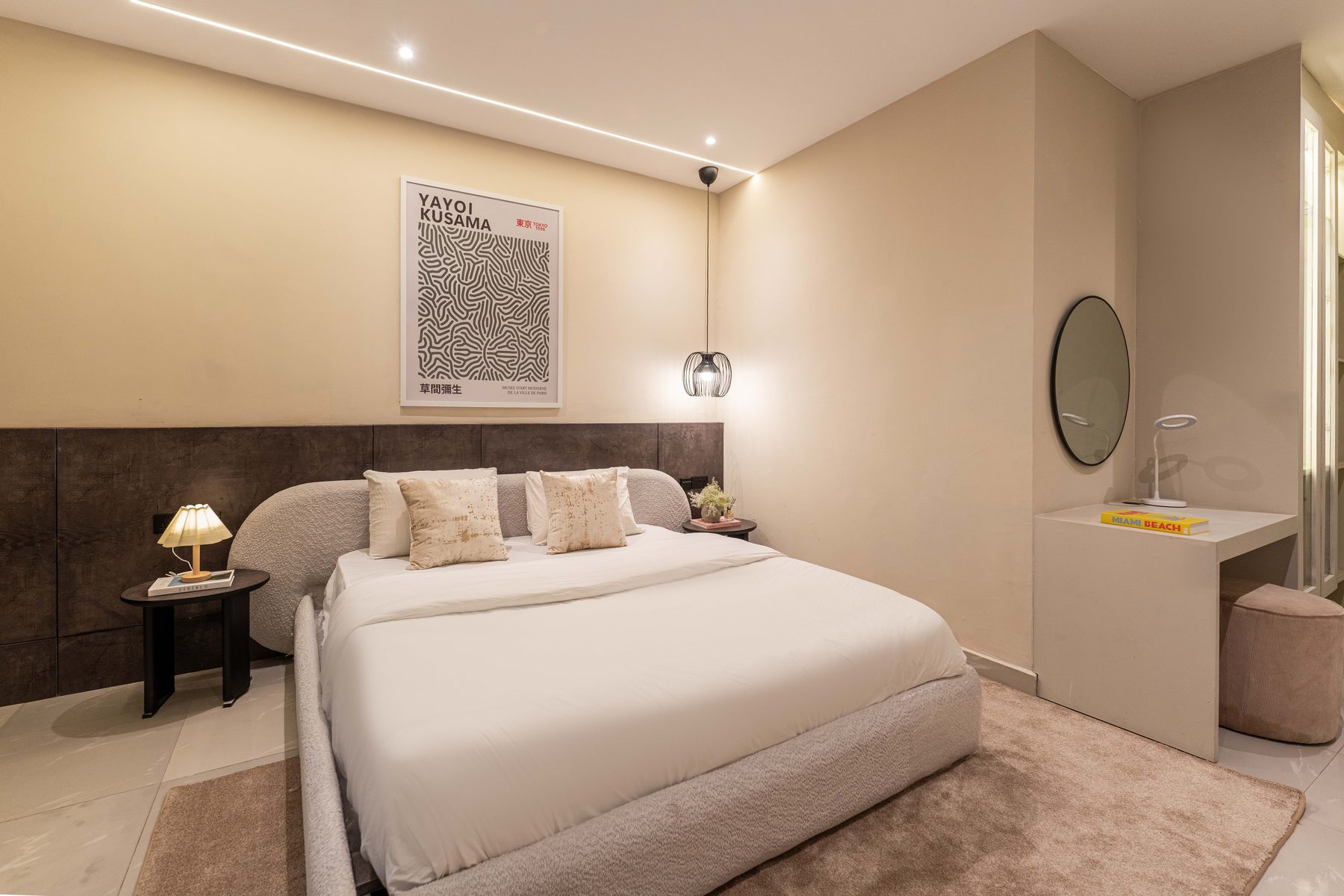 Bedroom at The Metropolis Lekki with boucle bed and soft lighting